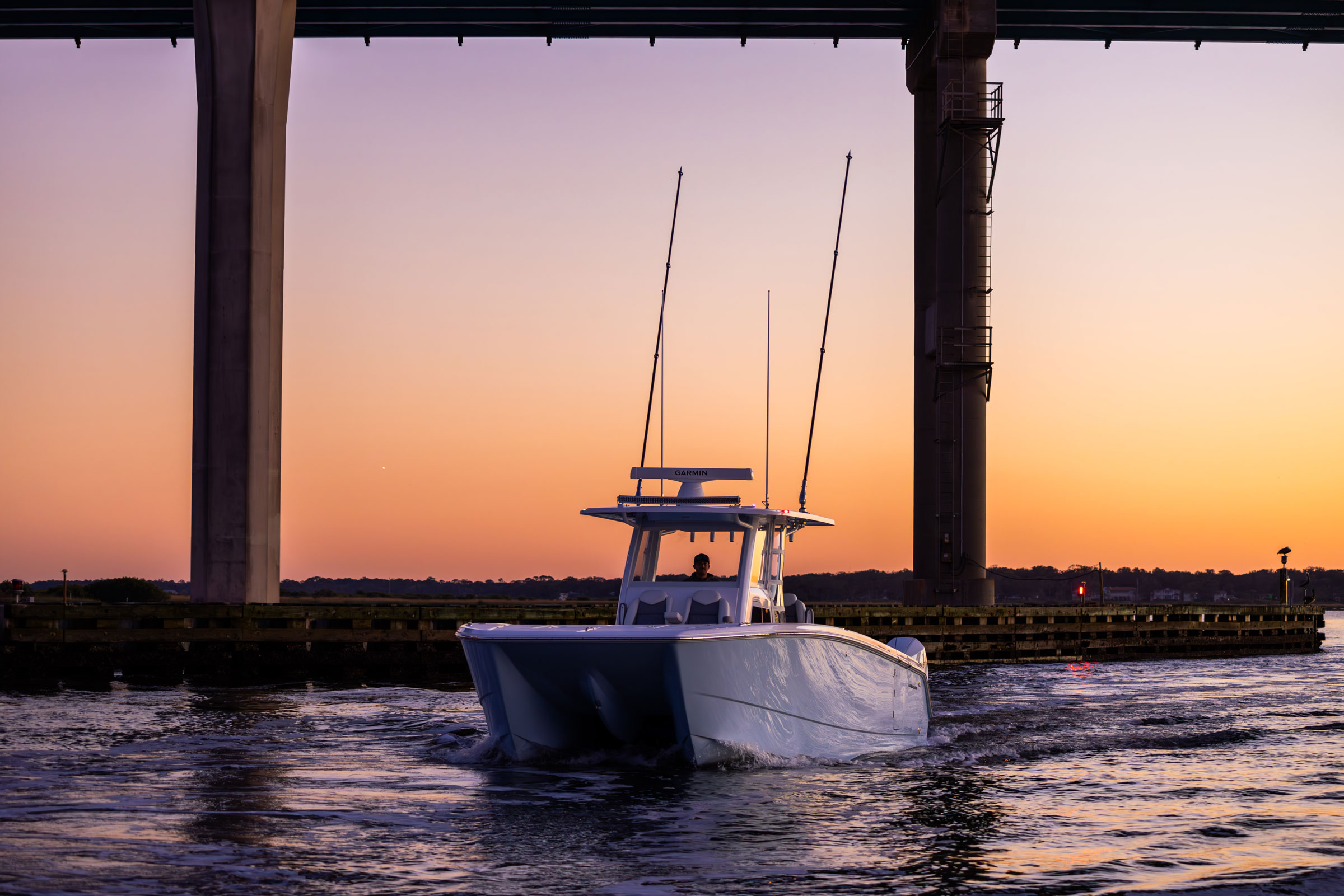 Invincible 38' Catamaran with sunset behind the boat