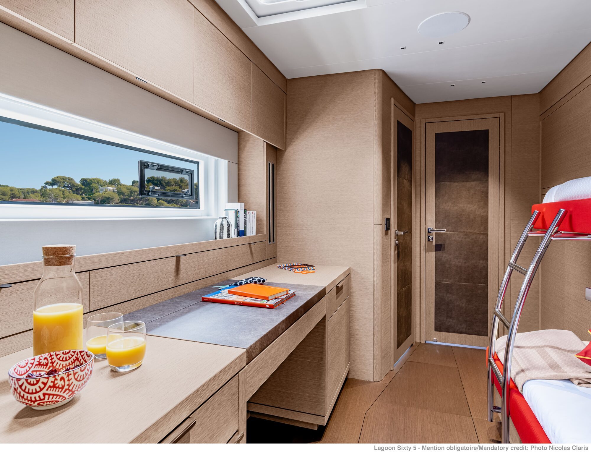 Lagoon 65 catamaran guest cabin with desk area and bunk beds Lagoon 65 catamaran guest cabin with desk area and bunk beds